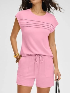 Detail of pink lounge set showing horizontal pleats and drawstring waist shorts
