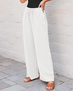 Detail of high waist wide leg pants showing natural linen texture and drawstring buttons