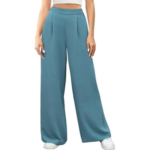 Close-up of high-waisted wide-leg trousers in dusty blue featuring elegant waist pleats