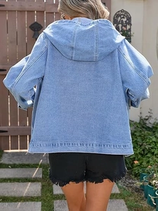 Detail view of oversized light blue denim jacket with drawstring hood and back stitch seam