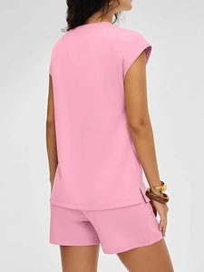 Detail of pink summer knit set showing rolled sleeve cuffs and side split hem on top