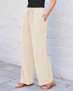 Detail of high waisted wide leg linen trousers with drawstring waist and button closure