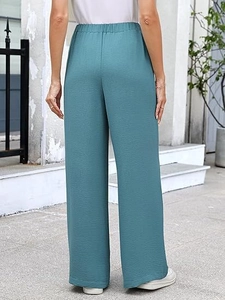 Detail of high-waisted wide-leg pants featuring premium crinkle texture and back view