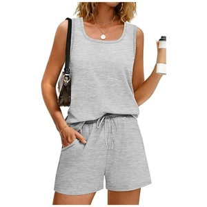 Detail of grey knitted two-piece set featuring a scoop neck tank top and shorts with pockets