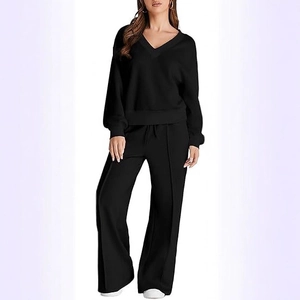 Women's black V-neck loungewear set featuring long sleeve top and wide-leg knit trousers