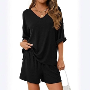 Casual black two-piece lounge set with V-neck top and high waist shorts in ribbed knit
