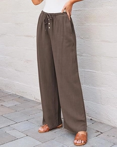 Detail of coffee brown linen wide-leg pants with elastic drawstring waist and white buttons