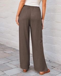 Rear view of brown high waisted wide leg pants featuring comfortable elastic waistband