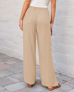 Detail view of khaki high waist wide leg pants with elastic waist and linen texture