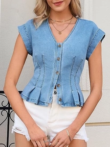 Detail of V-neck denim vest featuring structured waist pleats and metal button closure