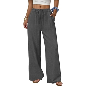 Detail of dark grey wide-leg pants featuring elastic drawstring waist and side pockets