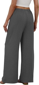 Macro view of dark grey wide-leg trousers showing elastic waistband and linen texture