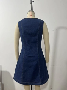 Detail view of back side of slim fit denim dress with contrast stitching on mannequin