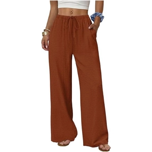 Detail of caramel high waist wide leg pants with drawstring closure and soft cotton fabric