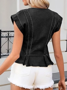 Detail of ruffled hem and white contrast stitching on the back of a black denim top
