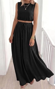 Close-up of black pleated fabric texture on sleeveless crop top and maxi skirt set