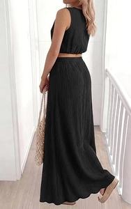 Detailed view of women's black sleeveless crop top and high waist pleated maxi skirt set
