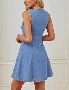 Detailed view of light blue denim sleeveless dress with round neck and vertical seams