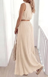 Detail of beige two-piece set showing side-back view of sleeveless crop top and maxi skirt