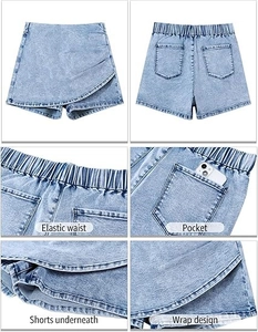 Detail view of light blue denim skort with wrap design and elastic waist features