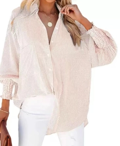 Detail of vertical stripes and elastic cuffs on a loose-fitting long sleeve V-neck shirt
