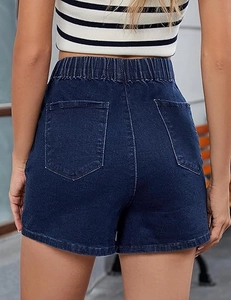 Rear view of high waisted dark blue denim shorts featuring elastic band and back pockets
