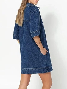 Detail view of deep blue denim shirt dress showing side pockets and loose fit design