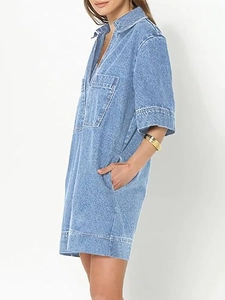 Close-up of light blue denim dress featuring a V-neck collar and large chest pockets