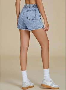 Detail of high waist denim skirt with elastic waistband and snow wash texture