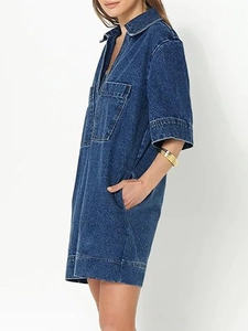 Close-up of deep blue denim dress featuring V-neck collar and functional side pockets