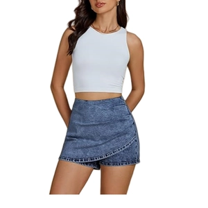 Detail of high waisted asymmetric blue denim skort with wrap front and side ruffles