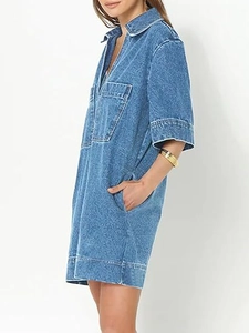 Side view detail of loose denim mini dress featuring V-neckline and cargo pockets