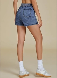 Detail view of high waist denim shorts with elastic waist and back pockets in washed blue