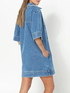 Side view detail of a loose denim dress featuring a practical hidden side seam pocket
