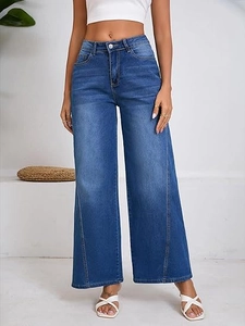 Detail of high-waisted wide-leg jeans in dark blue denim with vertical seam decoration