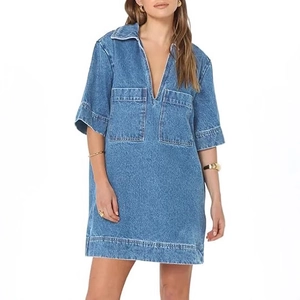 Short sleeve denim dress with V-neckline and large front pockets in mid-blue wash
