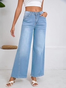 Detail view of light blue high waist wide leg jeans with vertical stitching and metal button