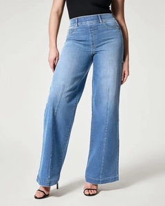 Detail of high waisted wide leg jeans with front vertical pleat in light blue wash