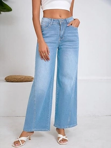 Detail shot of light blue high waisted wide leg jeans with vintage washed denim finish