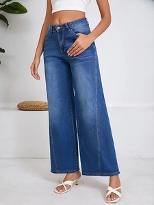 Detail of high-waisted wide-leg jeans featuring vintage cat-whisker wash and loose fit
