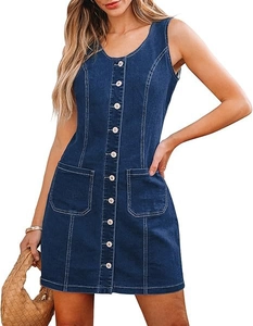 Detailed close-up of dark blue denim dress featuring metal buttons and stitch pockets
