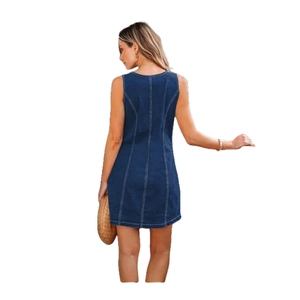 Detail view of stitching on sleeveless denim dress back with brown woven bag