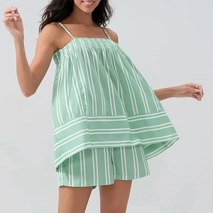 Close-up of green and white vertical striped two-piece summer set with smocked detail
