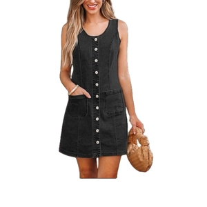 Detail view of the silver buttons and symmetric pockets on this black denim dress