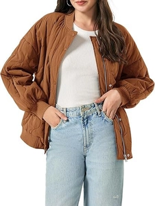 Close-up of brown quilted bomber jacket featuring wave pattern and ribbed cuffs