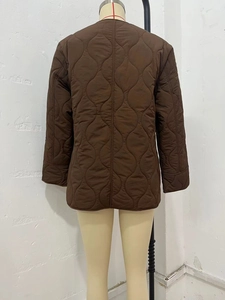 Back view of dark brown onion-quilted jacket with minimalist collarless loose fit design