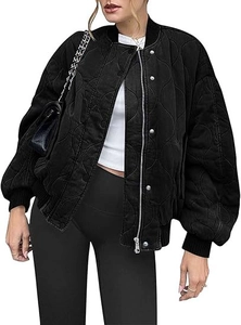 Detailed view of women black wavy quilted bomber jacket with silver zipper and snap buttons
