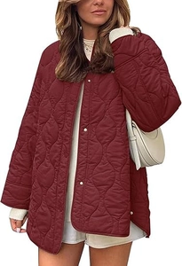 Detailed macro of the quilted texture and metallic buttons on this burgundy wine jacket