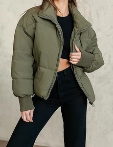 Detail of olive green puffer jacket featuring a high stand-up collar and ribbed elastic cuffs