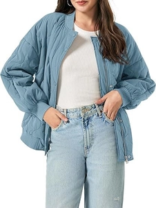 Detail of light blue wave-quilted jacket with navy ribbed cuffs and snap button closure